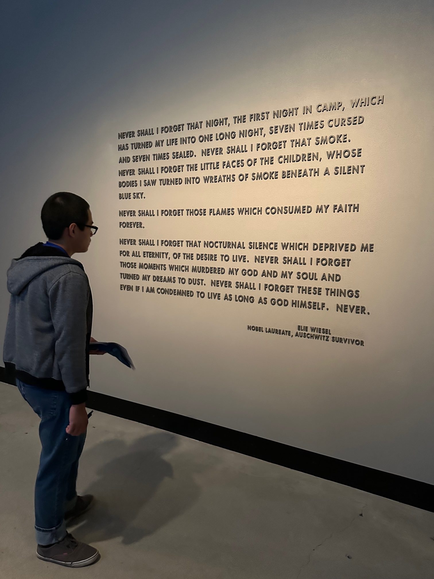 A student looking at a quote displayed in the museum